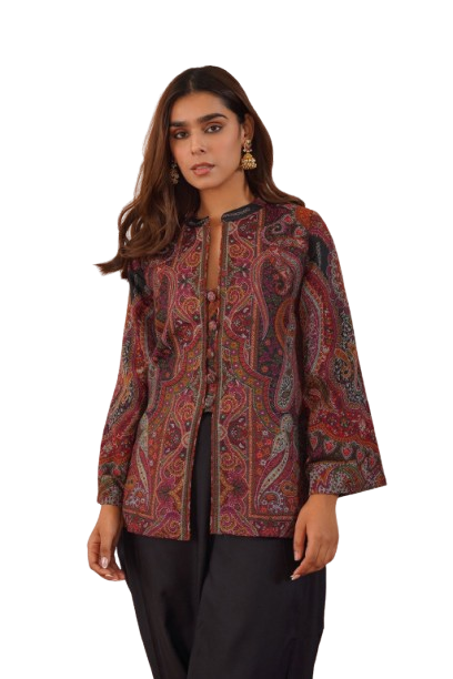 Woman wearing a paisley patterned jacket over black clothing.